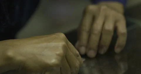 Hand holding silver string Stock Footage 141358995