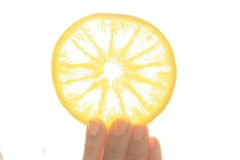 Hand holding a slice of orange Stock Photos