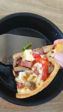 Hand holding slice of pizza Stock Photos