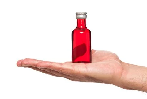 Hand holding a small bottle Stock Photos