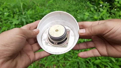 Hand Holding Small Broken Speaker in White Casing Outdoors Stock Footage 310263764