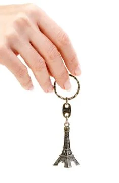 Hand holding small eiffel tower statuette 스톡 사진
