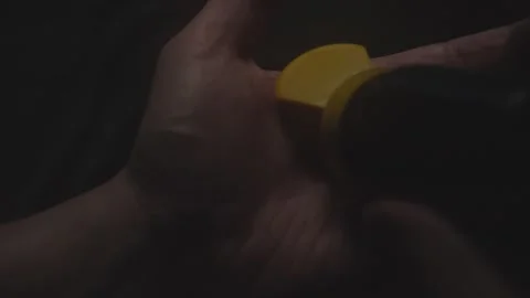 Hand Holding Small Pills in Dim Light Stock Footage 279106564