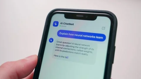 Hand holding smartphone with AI chatbot typing answer about neural networks 스톡 동영상 342129636