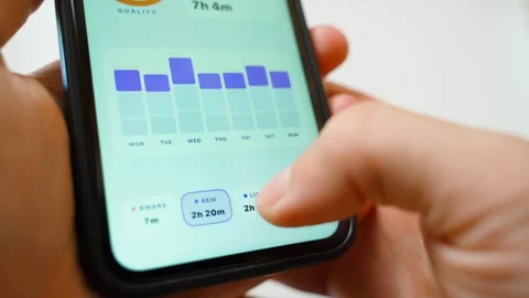 Hand holding smartphone analyzing sleep phases in tracking app close-up Stock Footage 341405928
