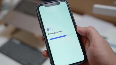Hand holding smartphone with app deleting user data and showing data deleted Video stock 342810891
