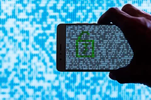 Hand holding a smartphone with a binary locker unlocked Foto stock