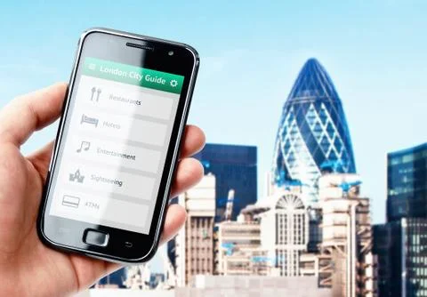 Hand holding smartphone with city guide on the screen in london Stock Photos