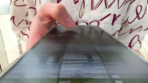 Hand holding a smartphone in close up during browsing. Finger taps and swip.. Stock Footage 334723208
