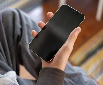 Hand Holding Smartphone with Empty Black Screen Fotos de archivo