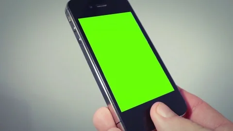 Hand holding smartphone with green screen Stock Footage 70607355