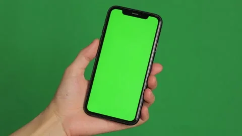 Hand holding smartphone with green screen Stock Footage 224431835