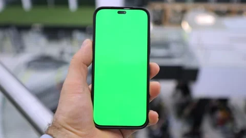 A Hand Holding a Smartphone with a Green Screen Ready for Editing and Stock Footage 286975250