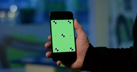 Hand Holding a Smartphone With a Green Tracking Screen Stock Footage 340294164
