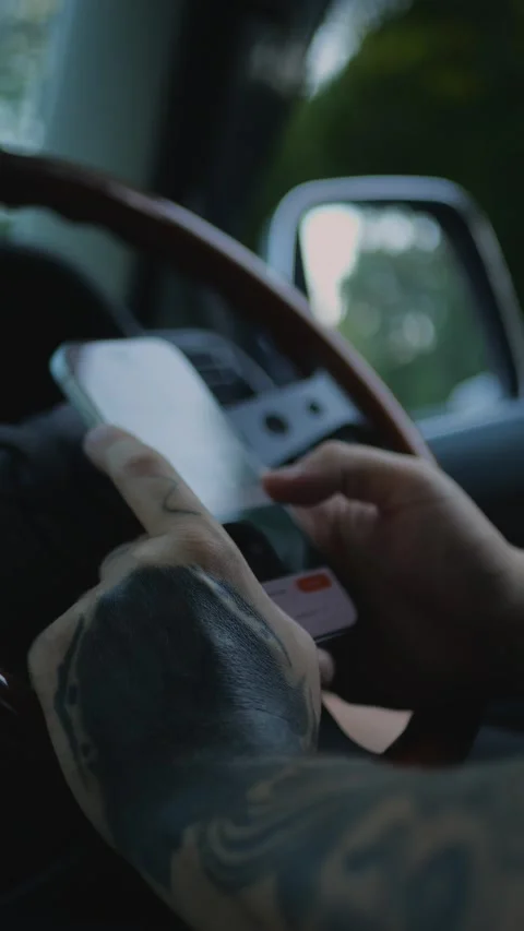 Hand holding smartphone inside a vehicle, representing automotive... Stock Footage 341613209