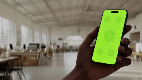 A hand holding a smartphone in a large Stock Footage 296943382