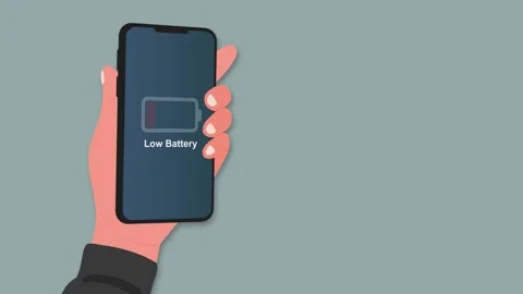 Hand holding a smartphone with Low Battery notification Stock Footage 342020943