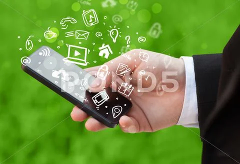 Hand holding smartphone with media icons and symbol Stock Photos