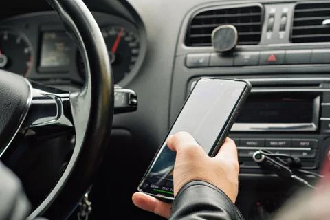 Hand holding a smartphone with navigation app open while driving, illustratin Stock Photos