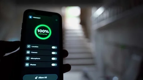Hand holding smartphone with privacy app showing full protection and permission Stock-Footage 342129305