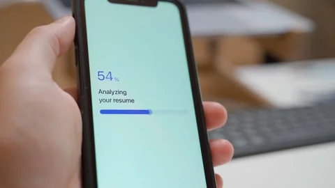 Hand holding smartphone with resume analysis frozen at seventy percent close-up Stock Footage 341078465
