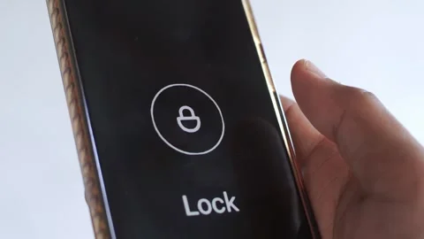 A hand holding a smartphone with a secure lock screen displayed Stock Footage 327215192