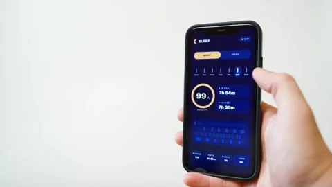 Hand holding smartphone with sleep tracking app in dark mode on white background Stock Footage 342129780