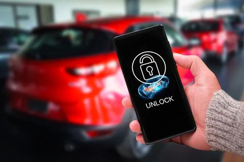 Hand holding a smartphone using a smart digital key application to unlock 库存照片
