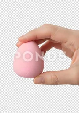 Hand holding soft pink makeup beauty sponge isolated on transparent background PSD Template