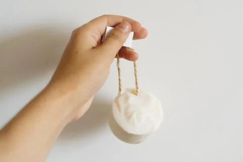 Hand holding solid shampoo bar, natural herbal soap or laundry soap on backgr 写真素材