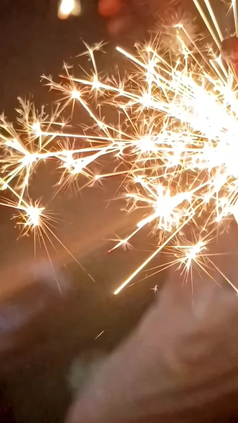 Hand Holding Sparkler Firework at Night, Bright Burning Sparkler Stock Footage 329588704