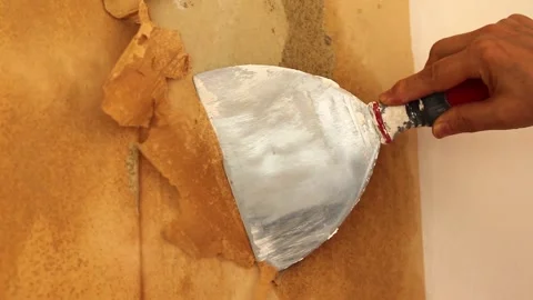 Hand holding spatula is removing wall paper Stock Footage 316073997