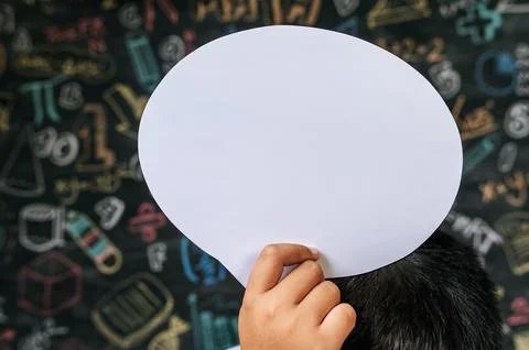 Hand holding speech bubble in class room Stock Photos