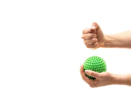 Hand holding sphere with spines while right fist crushes it Stock-Fotos