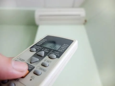 Hand is holding the split remote Stock Photos