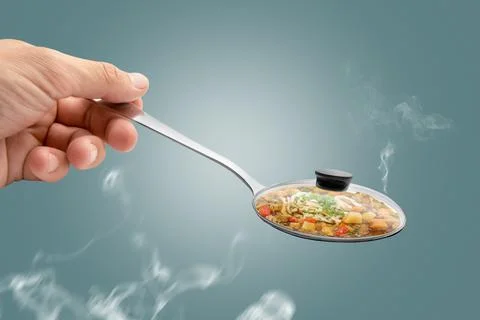 Hand holding spoon Stock Photos