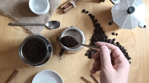 Hand holding a spoon preparing some expresso cafe with a coffee pot Stock Footage 112405186