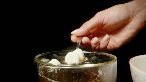 Hand Holding Spoon Scooping Marshmallows from Coffee Mug with Dolly Zoom Effect, Stock Footage 312476041