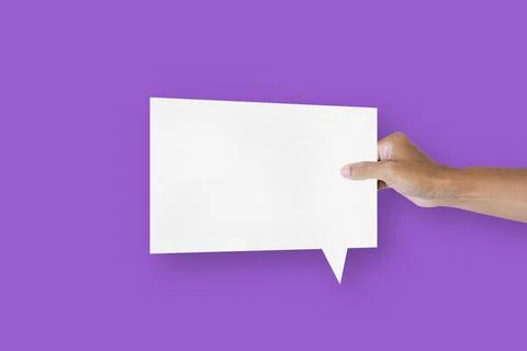 Hand holding a square shaped white paper balloons speech bubbles isolated o.. Stock Photos