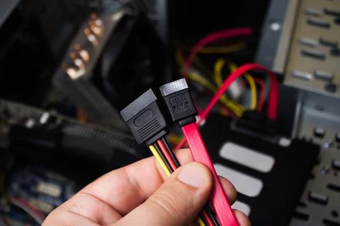 Hand holding SSD cables. Stock Photos