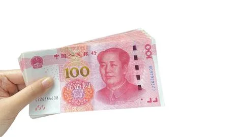 Hand Holding a Stack of 100 RMB Banknotes Against a White Background Foto stock