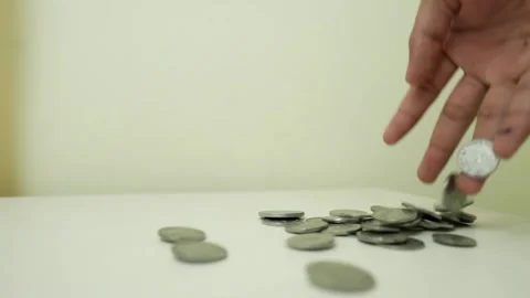 Hand Holding Stack of Coins Above Surface Stock Footage 317737402