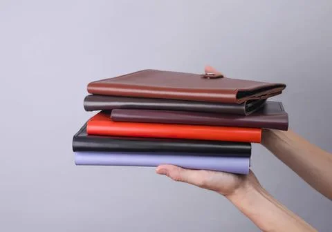 Hand holding stack of colorful notebooks and journals Stock Photos
