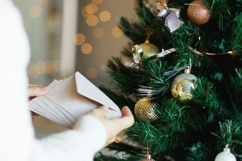 Hand holding stack of craft paper envelopes for christmas greeting card Stock Photos