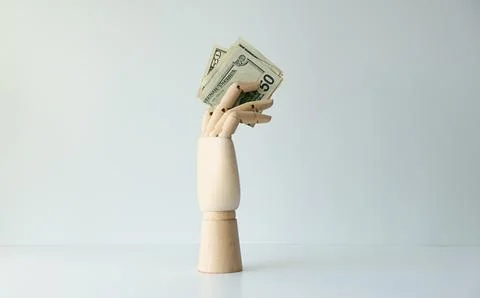 A hand holding a stack of fifty dollar bills Stock Photos