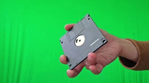 Hand Holding Stack of Floppy Disks on Green Screen Stock Footage 313913953