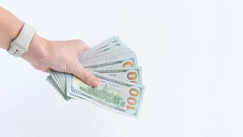 Hand Holding a Stack of Hundred Dollar Bills on White Backdrop. Financial Stock Photos