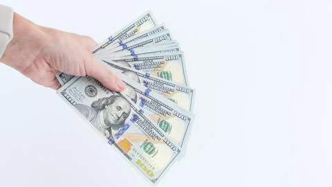 Hand Holding a Stack of Hundred Dollar Bills on White Background, Financial Stock Photos