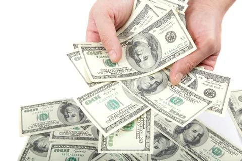 Hand holding a stack of money isolated on white background. Stock Photos