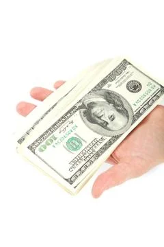 Hand holding a stack of money isolated on white background. Stock Photos